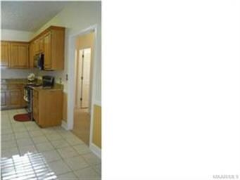 Kitchen view into hall which leads to bedrooms and