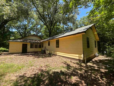 Rear view of property with central AC unit