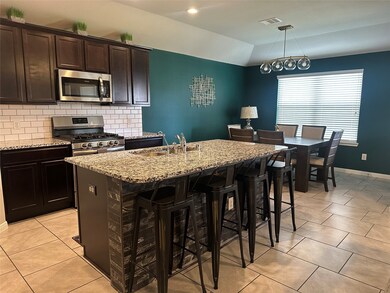 Kitchen with stainless steel appliances and breakfast area