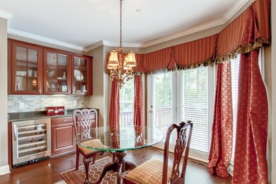 Breakfast Room has built-in raised panel cherry cabinets with glass front doors, large serving area and beverage refrigerator.  The atrium doors open onto the deck.