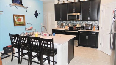 Kitchen area with Island bar and solid surface counters