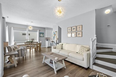 Living room featuring wood-type flooring, a chande