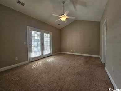 Carpeted empty room featuring ceiling fan, french 