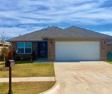Ranch-style home with a front yard and a garage