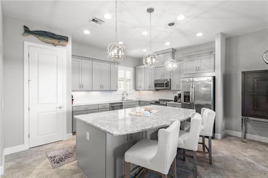 Kitchen with stainless steel appliances, a kitchen island, recessed lighting, tasteful backsplash, and a sink