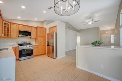 Kitchen featuring glass insert cabinets, visible v