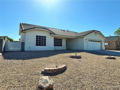 Ranch-style home with a tiled roof, stucco siding,