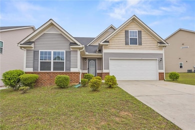 View of front facade with a front lawn, driveway, 