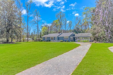 Ranch-style home featuring a front yard, a carport