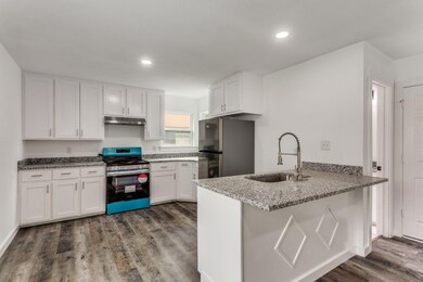 Kitchen with dark hardwood / wood-style floors, ki