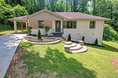 Ranch-style home featuring driveway, roof with shingles, a front lawn, an attached carport, and stone siding