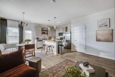 Living room featuring light wood-style flooring, b