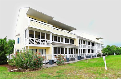 Back of property featuring central AC and a lawn