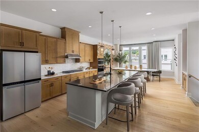 Kitchen featuring pendant lighting, a kitchen bar,