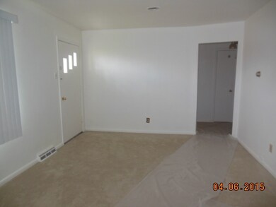 livingroom in front on east side of home (11.6' x 