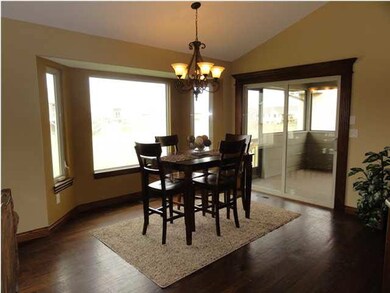 Large dining area with wood flooring.