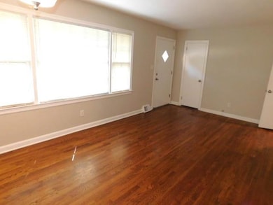 Entrance foyer with baseboards and dark wood-style flooring