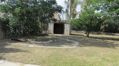 Back yard has shed. 