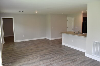 Empty room with hardwood / wood-style floors and sink