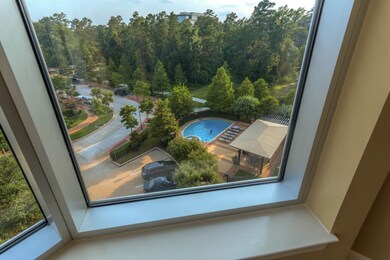 View of pool and serene setting below from 5th flo