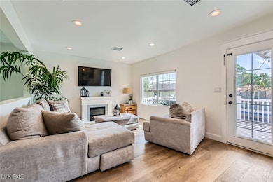 Living room with plenty of natural light, light wo