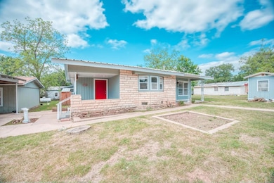 View of front of property with a front yard, a me