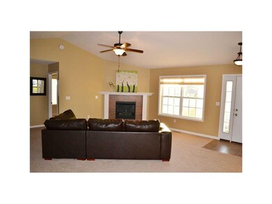 Great Room. Gas fireplace with tile surround & vau