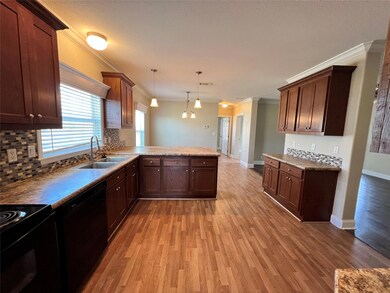 Kitchen with black appliances, a sink, ornamental
