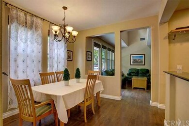 Formal dining room open to kitchen with more windo