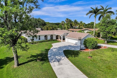Charm and Modern feel in this West Davie acre home