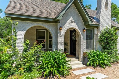 View of front of property featuring roof with shi
