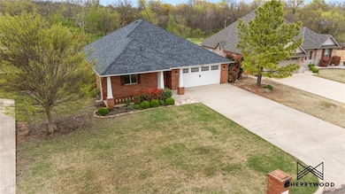 Ranch-style home featuring concrete driveway, an a
