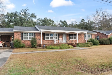 Ranch-style house featuring a front lawn, a porch,