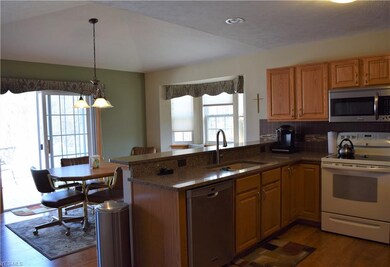 A bay window sitting area in the eat-it kitchen and a sliding door that leads out to a large vinyl deck with amazing views surrounded by nature. Enjoy beautiful mornings, afternoons and evenings bird watching off a large backyard deck or L.L walkout 