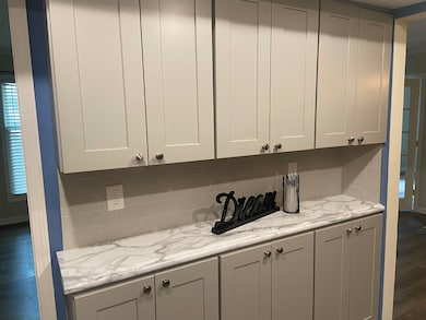 Kitchen featuring dark wood-style flooring, tastef