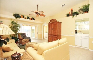 Tiled living room featuring ceiling fan