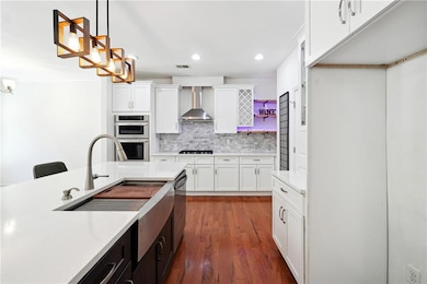 Kitchen featuring stainless steel appliances, wall