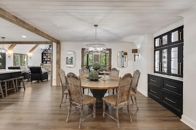 Dining space featuring a chandelier and dark wood-type flooring