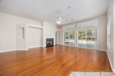 Unfurnished living room featuring ceiling fan and 