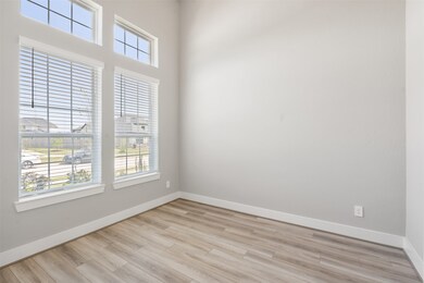 A home office with large windows overlooking a pea
