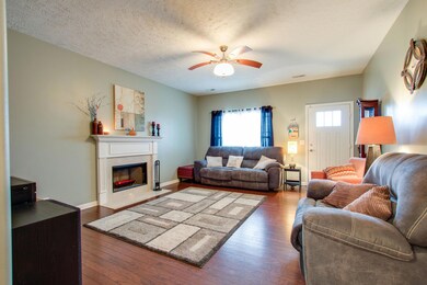 Welcoming living room with hardwood floor & ceiling fan.