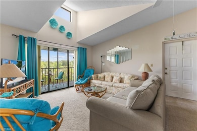 Living area with carpet, high vaulted ceiling, and healthy amount of natural light - only 3rd floor units offer a skylight
