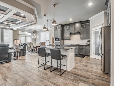Kitchen with stainless steel appliances, open floo