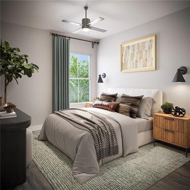 Bedroom with a ceiling fan and wood finished floor