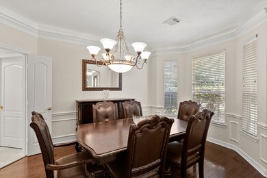 Dining room with wood floors, a beautiful chandeli