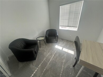Living area featuring carpet and baseboards