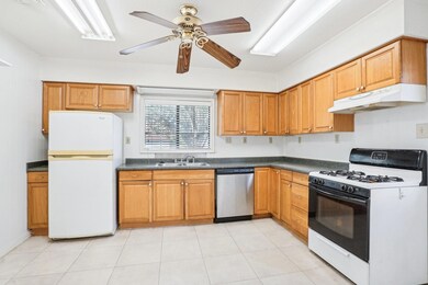 Kitchen with ceiling fan, light tile patterned flo