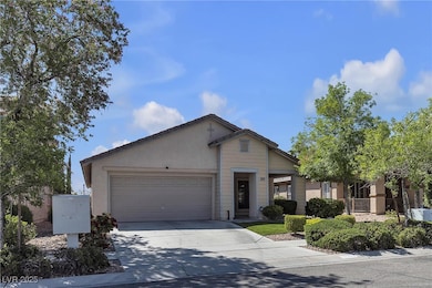 View of front facade with concrete driveway, a gar