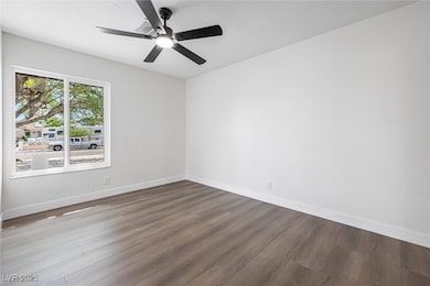 Unfurnished room featuring wood finished floors, b