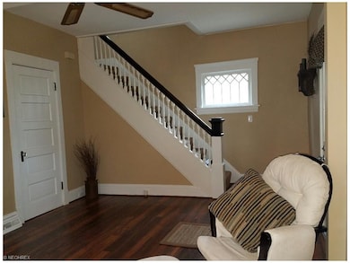 New wood laminate floors in LR and DR are beautiful! And what a gorgeous staircase and original window.
